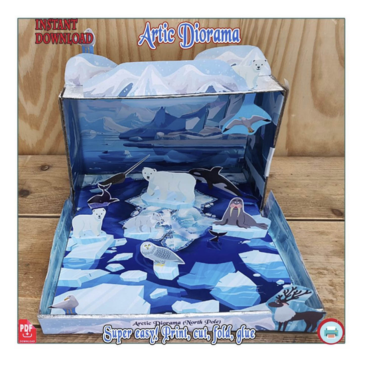 Completed Arctic animals shoebox diorama with paper polar bears, a walrus, a narwhal and an icy backdrop