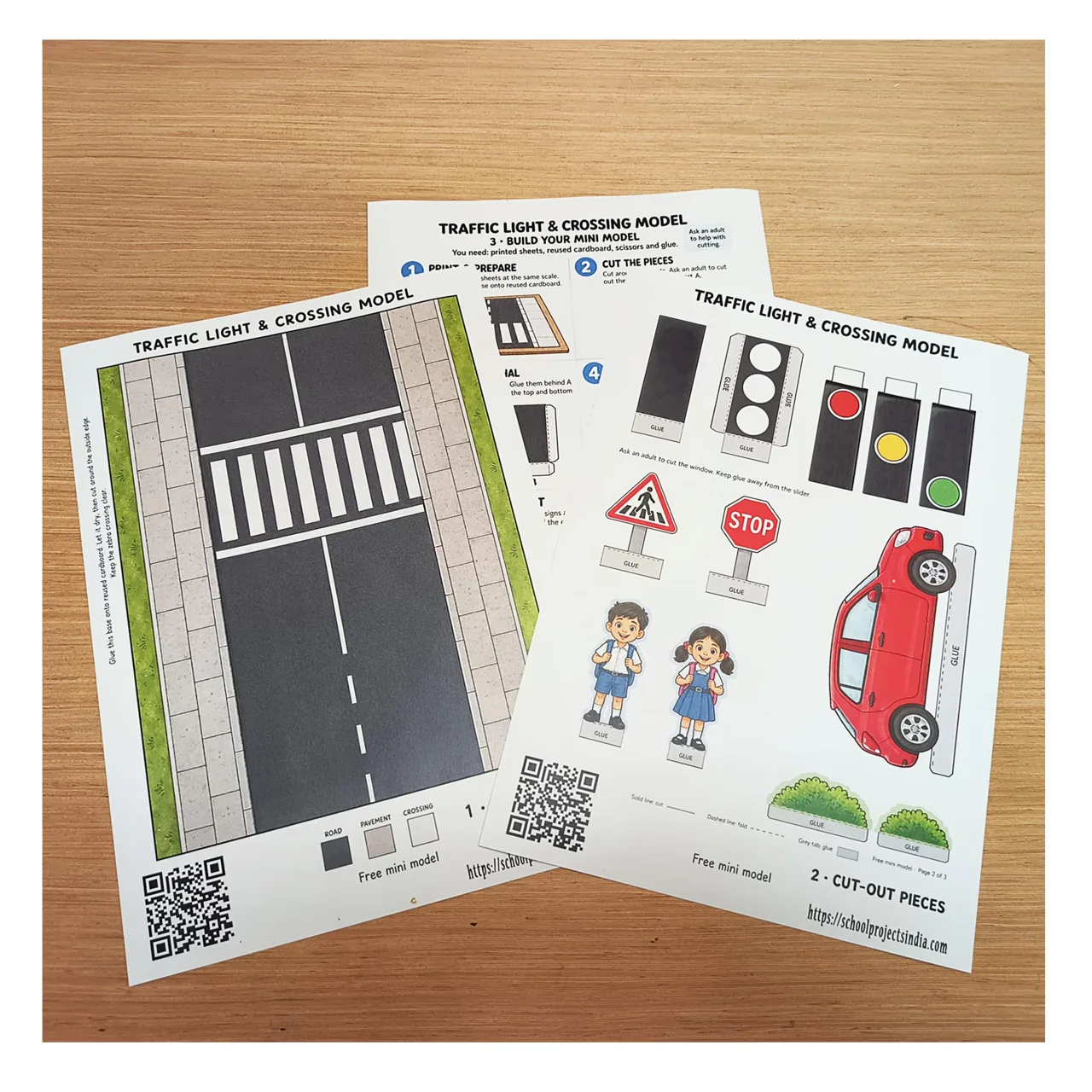 Three printed sheets for a road safety model, including a zebra crossing, cut-out figures and assembly instructions.