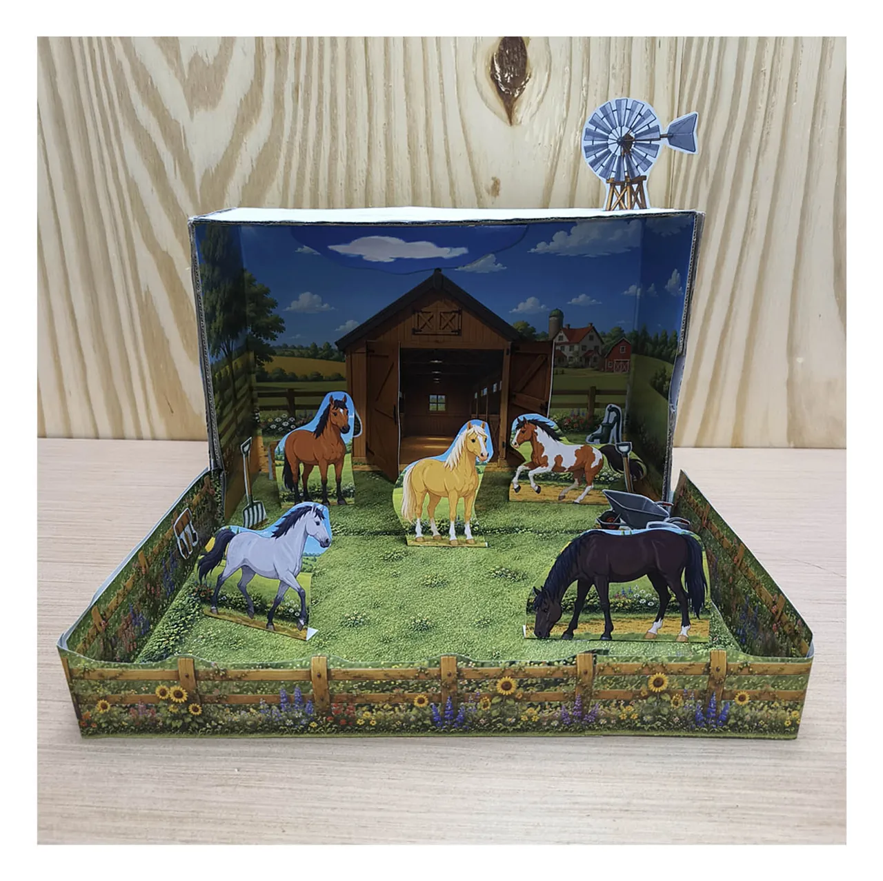 Shoebox horse stable and paddock model with five paper horses, fences and a windmill