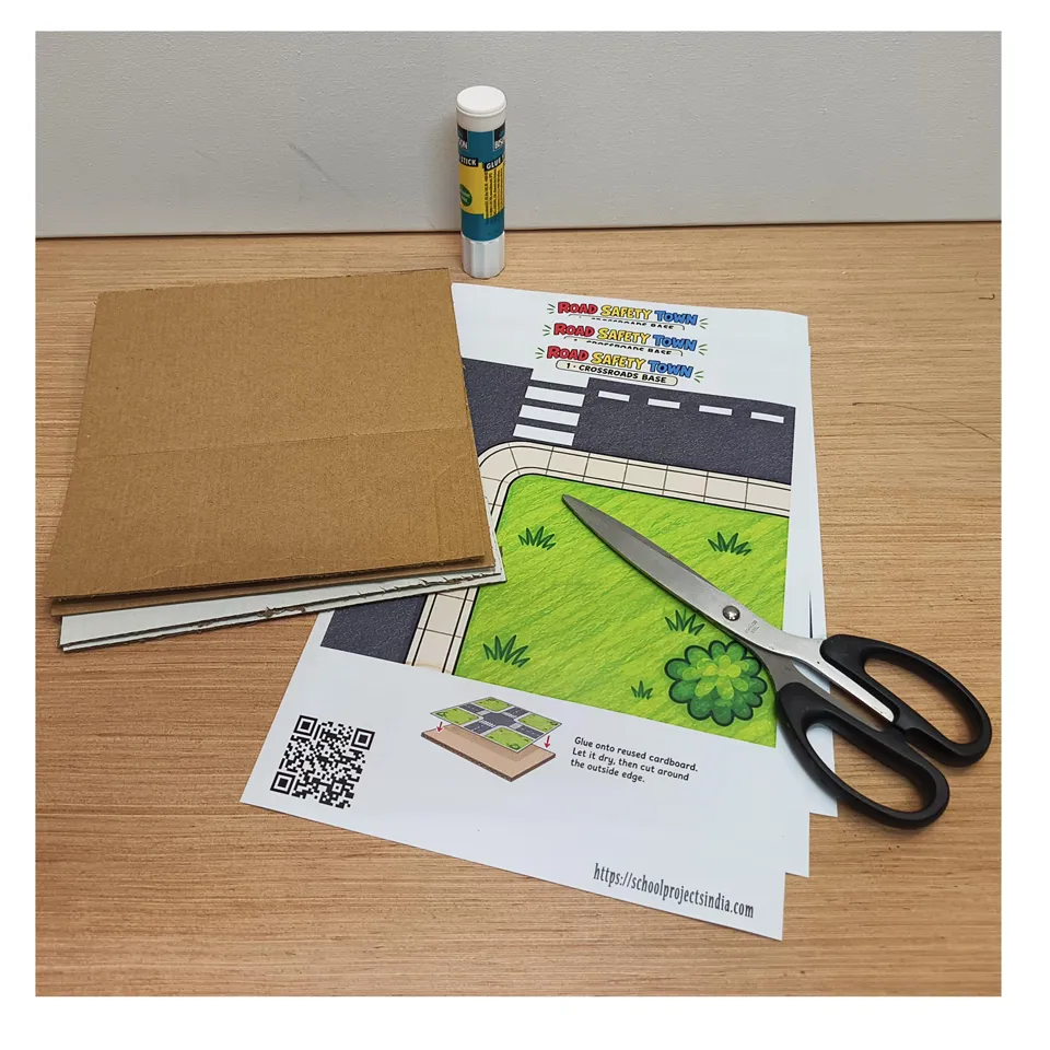 Cardboard, scissors, glue and printed road templates ready for assembly