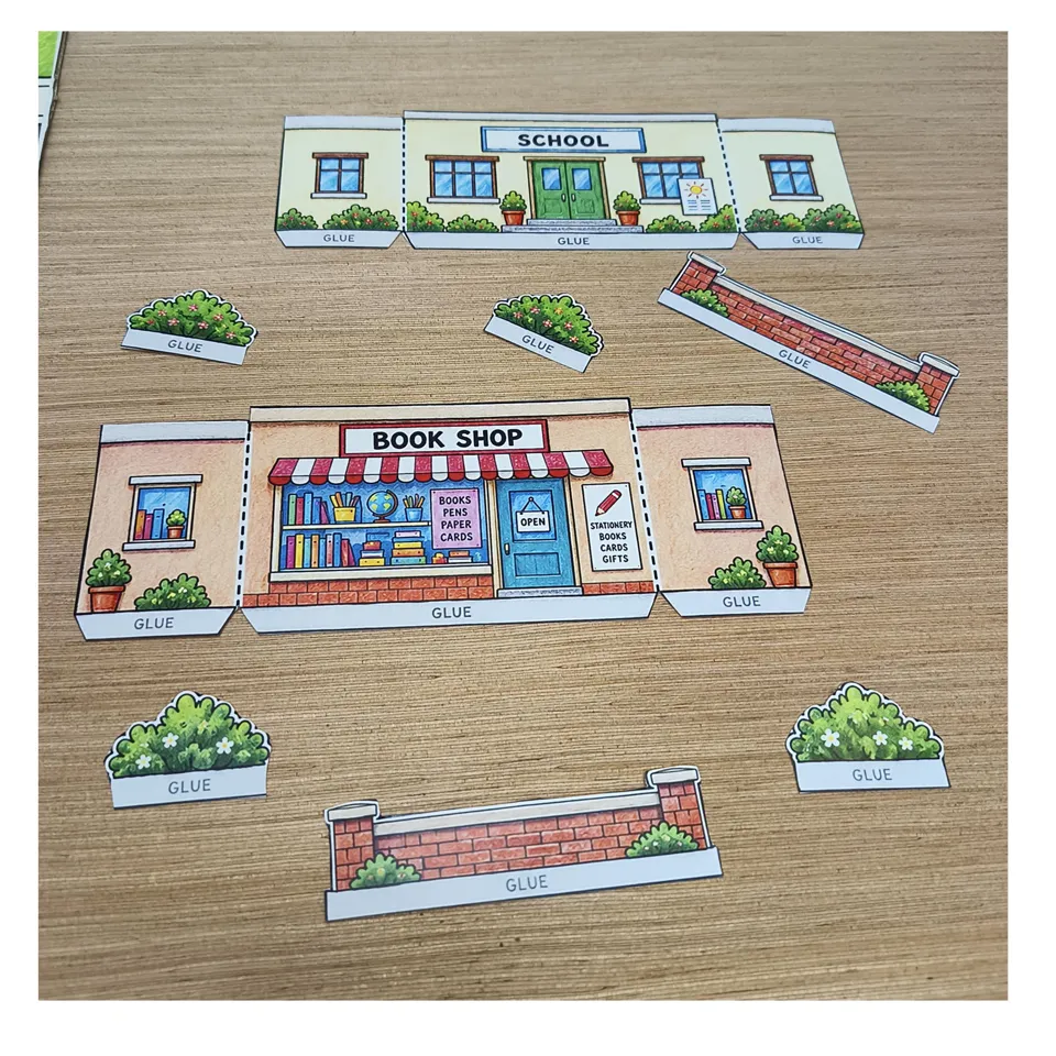 Cut-out school, bookshop, flower beds and low walls before folding