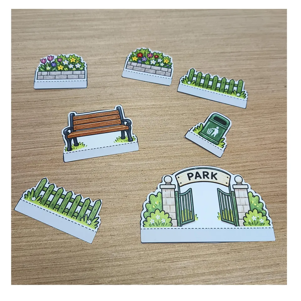 Cut-out park gate, bench, fences, flowers and litter bin