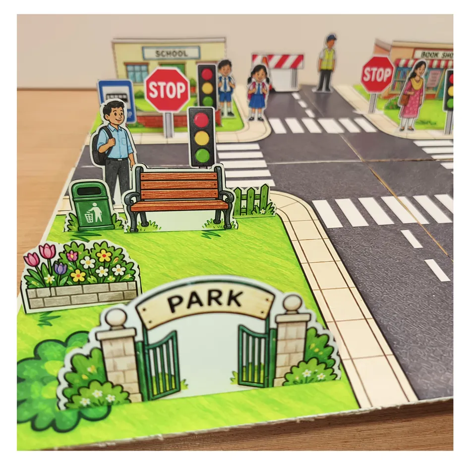 Paper park beside a road junction with traffic lights and pedestrians
