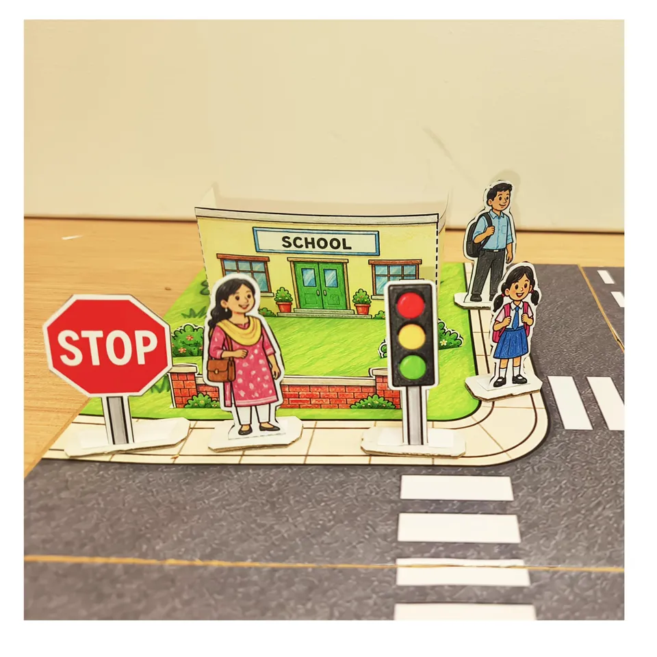 Schoolchildren and an adult beside the school and traffic light