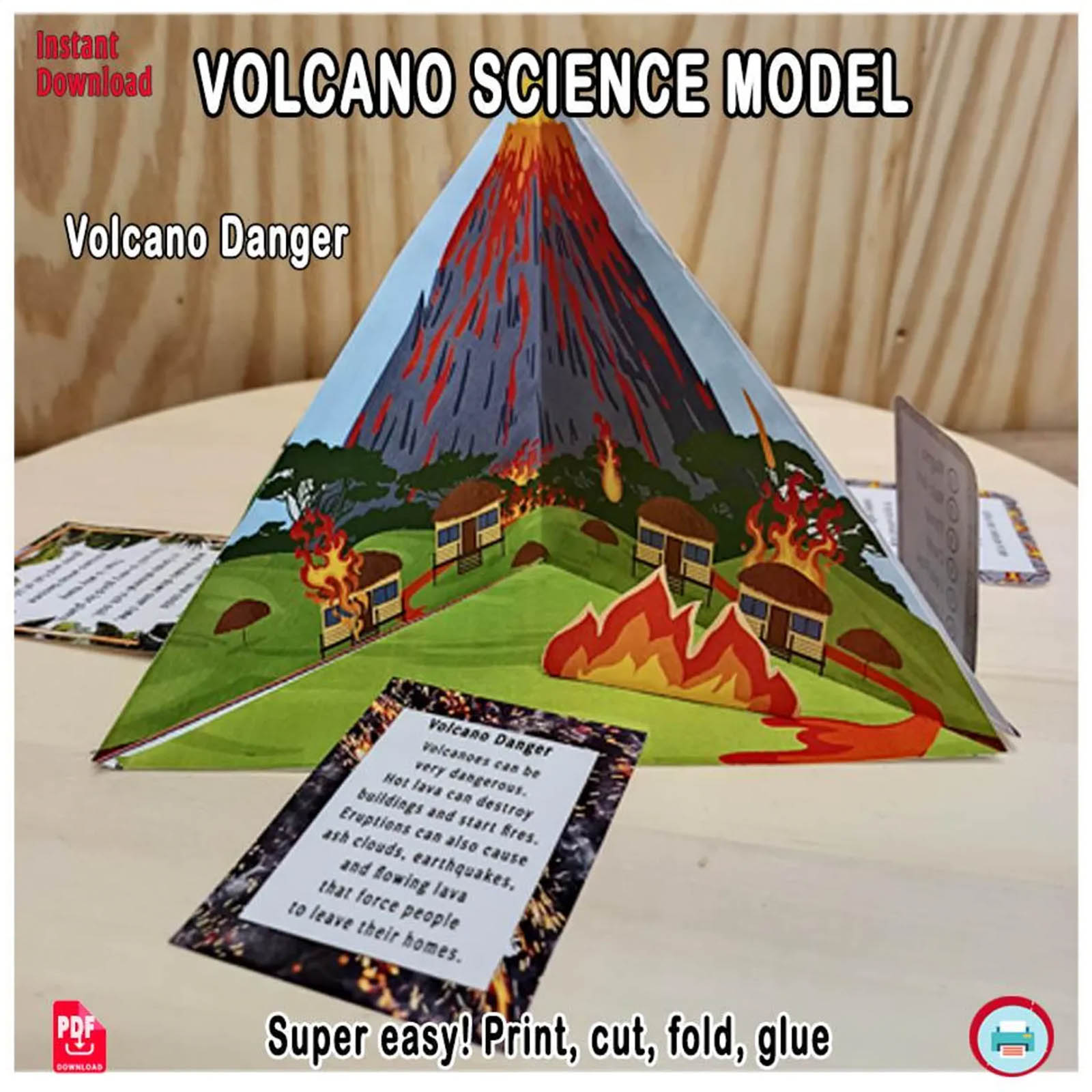Paper volcano school project scene showing lava flows, houses and fire to illustrate eruption hazards