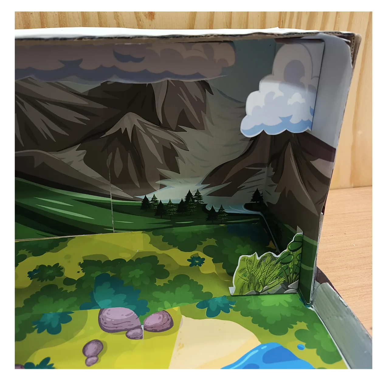 Close-up of a paper cloud and bushes inside the model