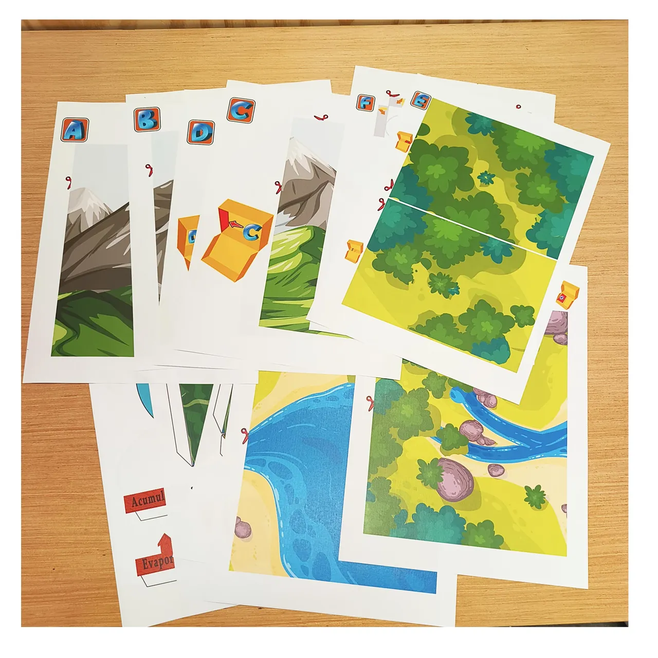 Printed water cycle template sheets laid out before assembly