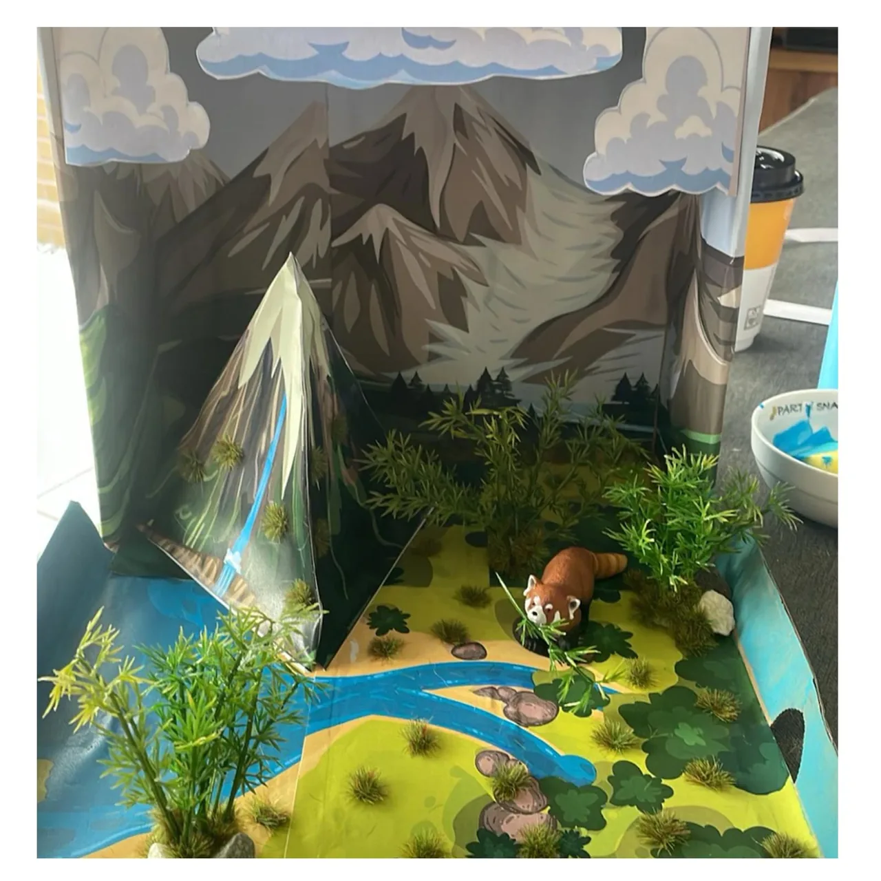 Student water cycle project with added plants and physical objects