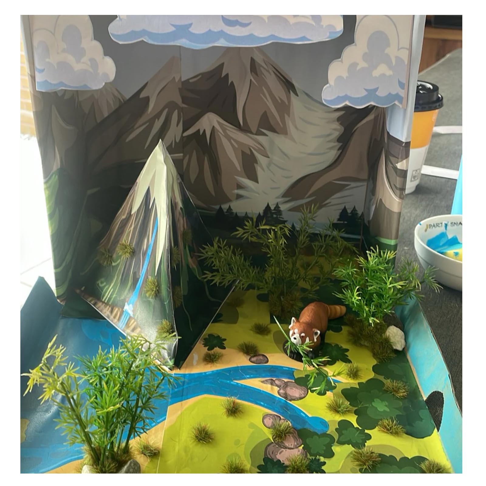 Student water cycle project with added plants and physical objects